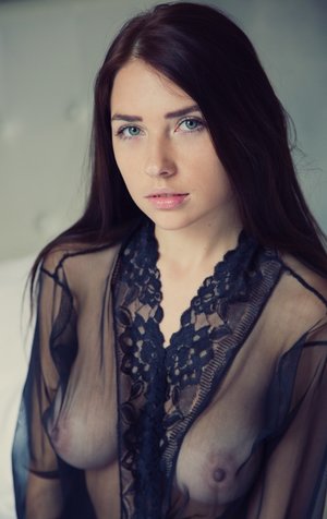 18 year old girl Megan Rain removes her sandals and then clothes to pose naked